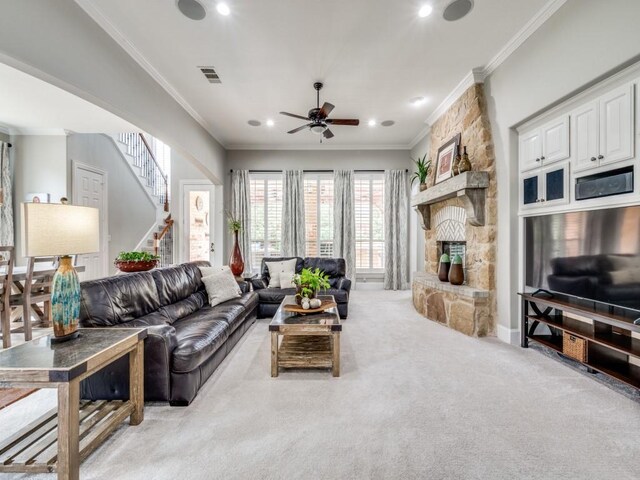 11483 Mirage Ln, Frisco, TX 75033 - living room with ornamental molding, light colored carpet, a ceiling fan, a fireplace, and recessed lighting