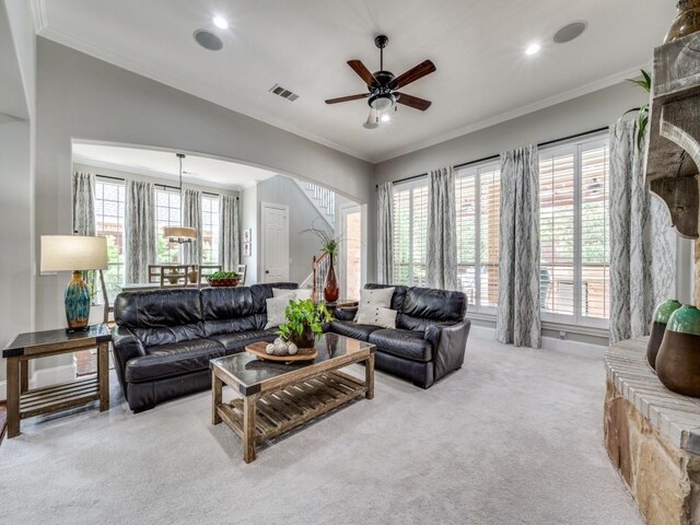 11483 Mirage Ln, Frisco, TX 75033 - carpeted living room featuring arched walkways, healthy amount of natural light, a ceiling fan, ornamental molding, and recessed lighting