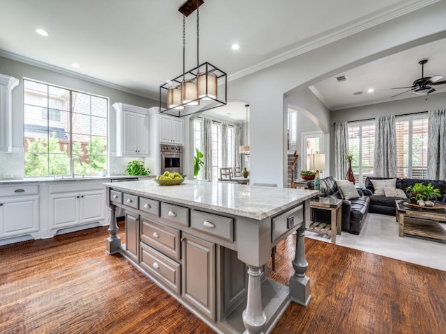 11483 Mirage Ln, Frisco, TX 75033 - kitchen featuring stainless steel oven, arched walkways, open floor plan, a ceiling fan, and a sink