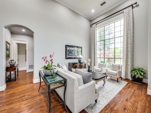 11483 Mirage Ln, Frisco, TX 75033 - living room with arched walkways, crown molding, baseboards, wood finished floors, and recessed lighting