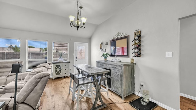 229 Willow Creek Dr, Weatherford, TX 76085 - dining area featuring lofted ceiling, a chandelier, light wood finished floors, and baseboards