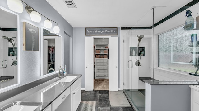 229 Willow Creek Dr, Weatherford, TX 76085 - full bathroom with a shower stall, vanity, a walk in closet, and wood finished floors