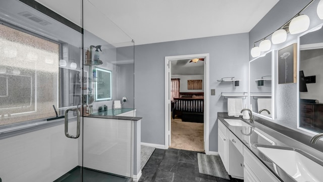 229 Willow Creek Dr, Weatherford, TX 76085 - bathroom featuring double vanity, a stall shower, baseboards, and ensuite bathroom