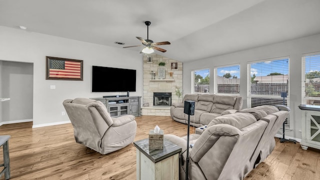 229 Willow Creek Dr, Weatherford, TX 76085 - living room featuring vaulted ceiling, a ceiling fan, light wood finished floors, baseboards, and a fireplace