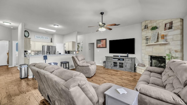 229 Willow Creek Dr, Weatherford, TX 76085 - living room with a ceiling fan, light wood-type flooring, and a fireplace