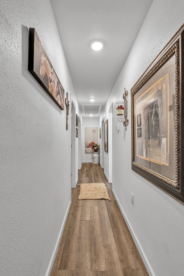 201 E Pearl St, Celeste, TX 75423 - hall featuring attic access, wood finished floors, a textured wall, and baseboards