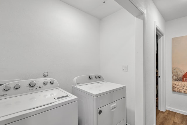 201 E Pearl St, Celeste, TX 75423 - laundry room featuring washer and dryer, wood finished floors, and baseboards