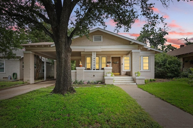 1425 W Gambrell St, Fort Worth, TX 76115 - view of front of home featuring driveway, a carport, covered porch, a front lawn, and brick siding