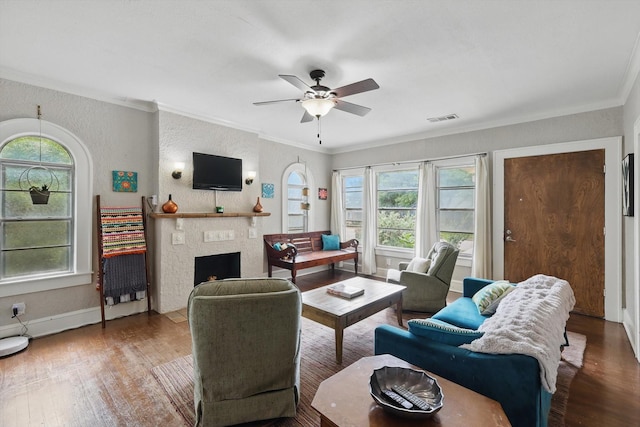 1425 W Gambrell St, Fort Worth, TX 76115 - living room with crown molding, wood finished floors, ceiling fan, a fireplace with flush hearth, and baseboards