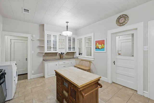 1425 W Gambrell St, Fort Worth, TX 76115 - kitchen featuring white cabinetry, glass insert cabinets, pendant lighting, baseboards, and open shelves