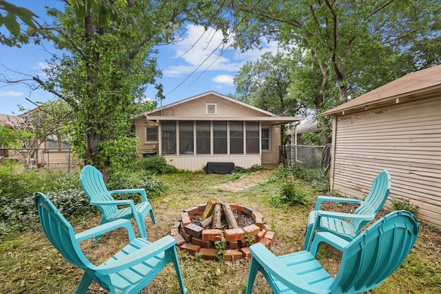 1425 W Gambrell St, Fort Worth, TX 76115 - back of house with an outdoor fire pit and a sunroom