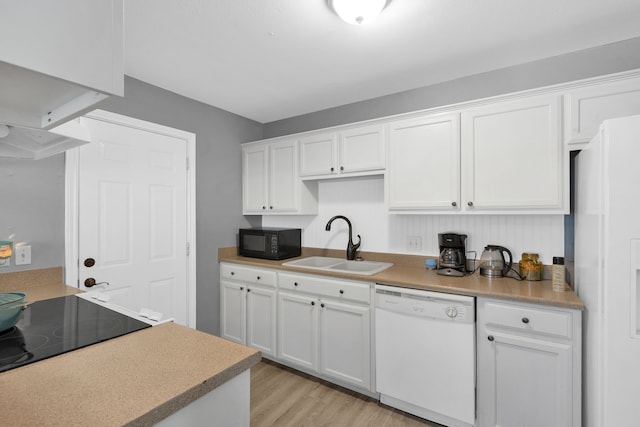 704 Windy Hl, Celeste, TX 75423 - kitchen with white appliances, a sink, white cabinetry, light wood-type flooring, and light countertops
