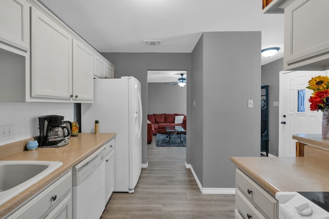 704 Windy Hl, Celeste, TX 75423 - kitchen featuring white appliances, ceiling fan, light wood-style flooring, and light countertops