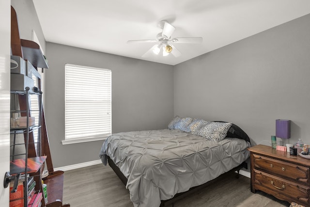704 Windy Hl, Celeste, TX 75423 - bedroom with baseboards, wood finished floors, and a ceiling fan