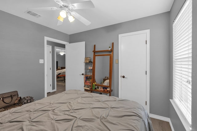 704 Windy Hl, Celeste, TX 75423 - bedroom with wood finished floors, multiple windows, baseboards, and ceiling fan