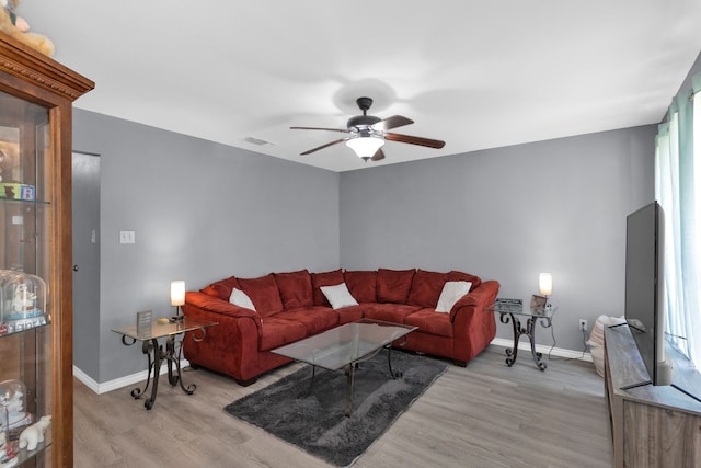 704 Windy Hl, Celeste, TX 75423 - living area featuring light wood finished floors, a ceiling fan, and baseboards