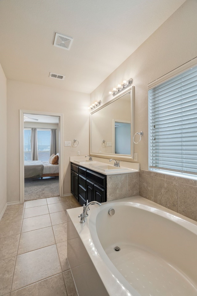 5420 Chinkapin Ln, Fort Worth, TX 76244 - ensuite bathroom with double vanity, a bath, tile patterned flooring, and baseboards