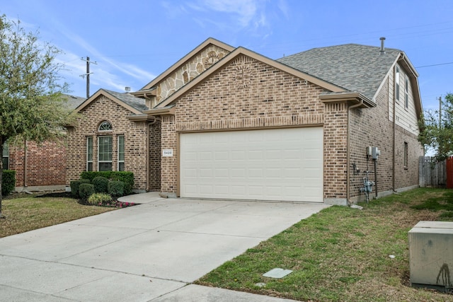 5420 Chinkapin Ln, Fort Worth, TX 76244 - view of front of house featuring an attached garage, brick siding, roof with shingles, and concrete driveway