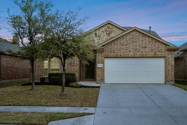 5420 Chinkapin Ln, Fort Worth, TX 76244 - view of front of house with an attached garage, concrete driveway, brick siding, and a front lawn