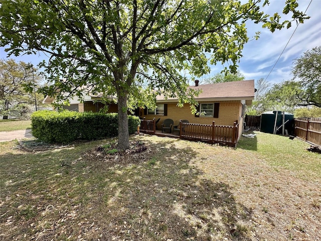 1002 Wrights W, Comanche, TX 76442 - view of front of property with a wooden deck and brick siding