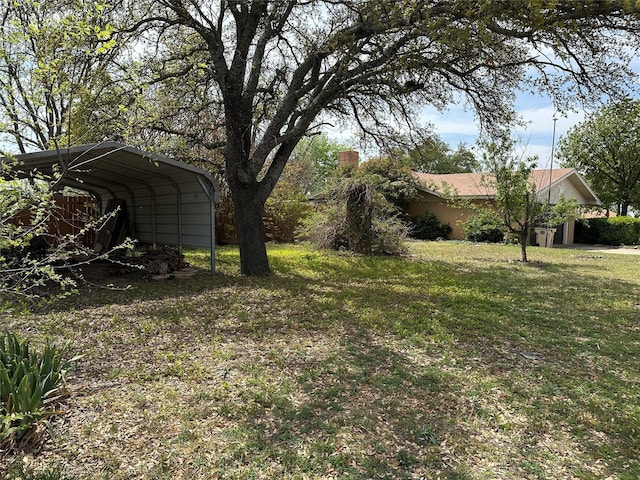1002 Wrights W, Comanche, TX 76442 - view of grassy yard featuring a carport