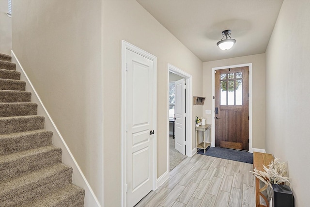 9117 Conroe Dr, Denton, TX 76226 - entrance foyer with stairs, baseboards, and light wood-style flooring