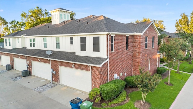 152 Leonard St, Lewisville, TX 75057 - view of side of property featuring central air condition unit, a shingled roof, brick siding, an attached garage, and concrete driveway