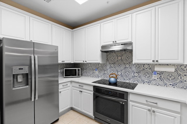 152 Leonard St, Lewisville, TX 75057 - kitchen featuring black appliances, under cabinet range hood, light countertops, white cabinets, and tasteful backsplash