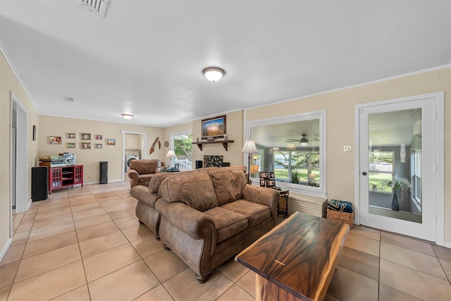 3917 N 31st St, Waco, TX 76708 - living area with light tile patterned flooring, a fireplace, and ornamental molding