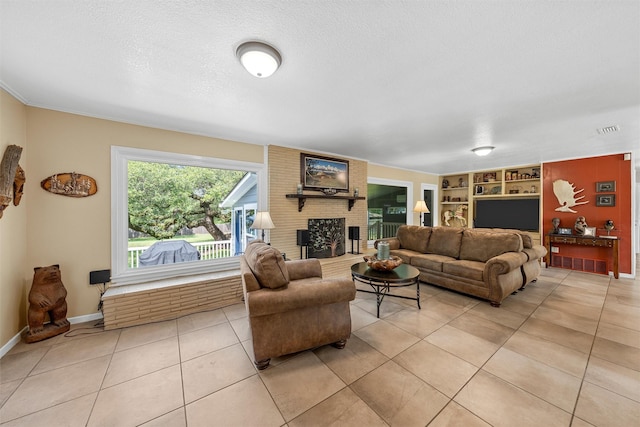3917 N 31st St, Waco, TX 76708 - living room featuring light tile patterned floors, a fireplace, baseboards, a textured ceiling, and built in shelves