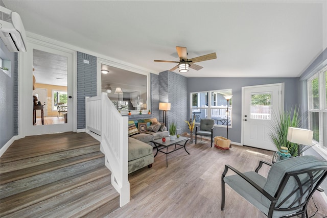 3917 N 31st St, Waco, TX 76708 - living area with an AC wall unit, wood finished floors, baseboards, ceiling fan, and vaulted ceiling