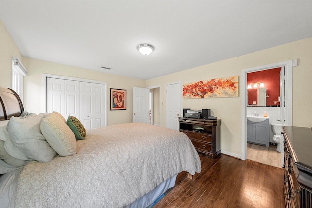 3917 N 31st St, Waco, TX 76708 - bedroom with dark wood-style flooring, a sink, a closet, ensuite bath, and baseboards
