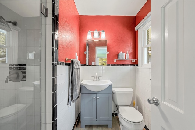 3917 N 31st St, Waco, TX 76708 - bathroom with toilet, tile walls, a stall shower, vanity, and plenty of natural light