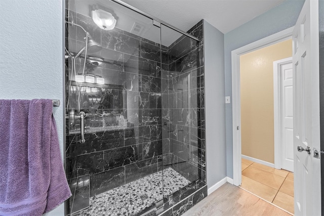3917 N 31st St, Waco, TX 76708 - full bathroom featuring a stall shower, tile patterned flooring, and baseboards