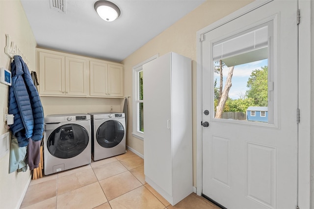 3917 N 31st St, Waco, TX 76708 - laundry area featuring washer and dryer, cabinet space, baseboards, and light tile patterned floors