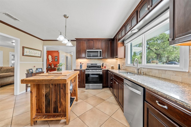 3917 N 31st St, Waco, TX 76708 - kitchen with appliances with stainless steel finishes, wooden counters, light tile patterned flooring, backsplash, and crown molding