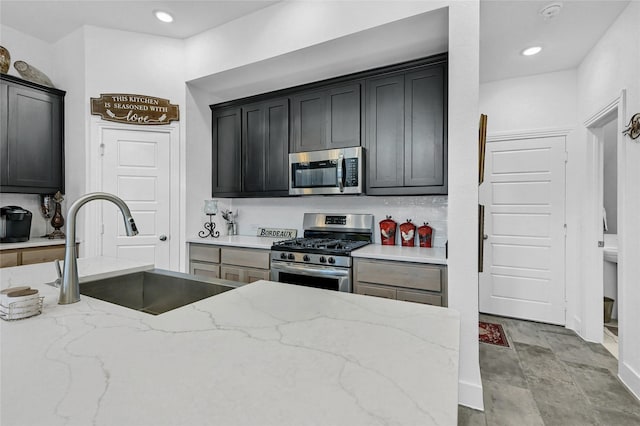 1134 Morgan Dr, Sherman, TX 75090 - kitchen featuring appliances with stainless steel finishes, a sink, light stone countertops, recessed lighting, and stone finish floors