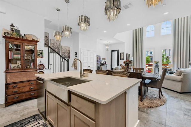 1134 Morgan Dr, Sherman, TX 75090 - kitchen with a chandelier, open floor plan, a sink, stone tile flooring, and an island with sink