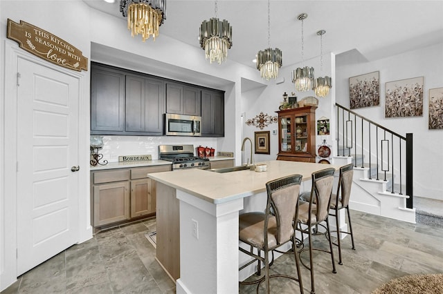 1134 Morgan Dr, Sherman, TX 75090 - kitchen featuring stainless steel appliances, a chandelier, a sink, and an island with sink