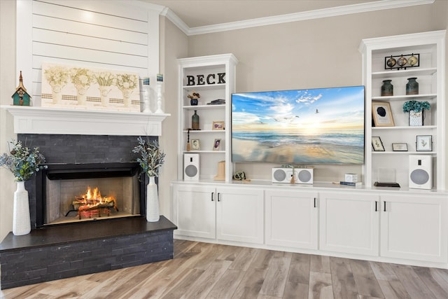 2141 Vanderbilt Dr, Weatherford, TX 76088 - living area featuring crown molding, a lit fireplace, and light wood finished floors
