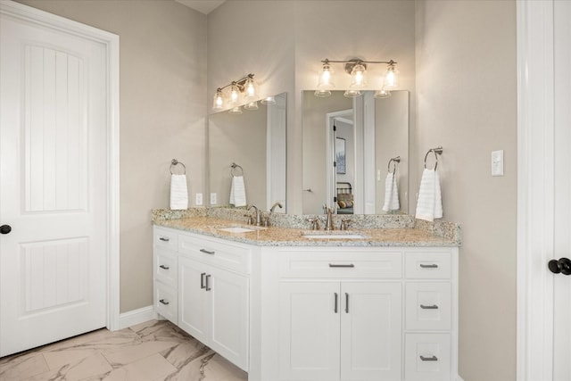 2141 Vanderbilt Dr, Weatherford, TX 76088 - bathroom with double vanity, marble look tiles, and baseboards