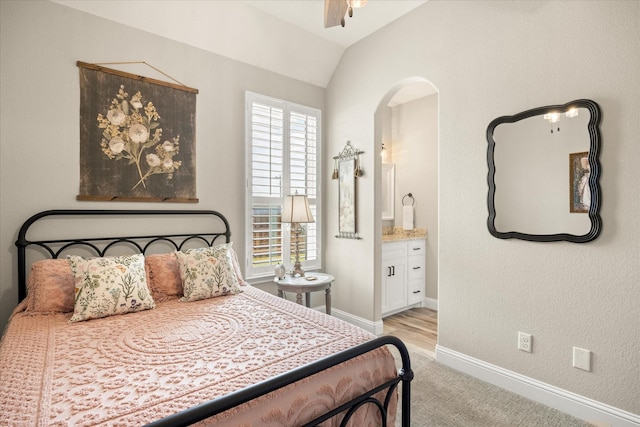 2141 Vanderbilt Dr, Weatherford, TX 76088 - bedroom with arched walkways, lofted ceiling, light colored carpet, connected bathroom, and baseboards