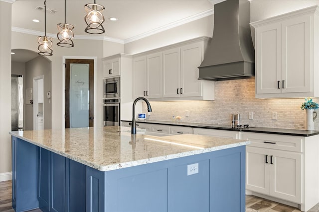 2141 Vanderbilt Dr, Weatherford, TX 76088 - kitchen featuring wall chimney exhaust hood, stainless steel appliances, ornamental molding, tasteful backsplash, and light stone counters