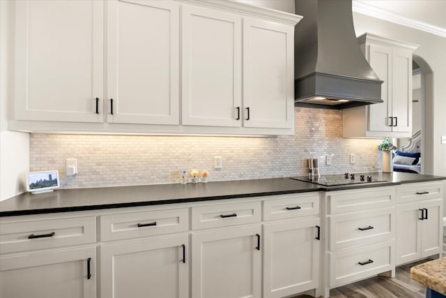 2141 Vanderbilt Dr, Weatherford, TX 76088 - kitchen featuring custom exhaust hood, black electric stovetop, white cabinets, dark countertops, and tasteful backsplash