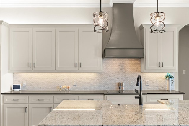2141 Vanderbilt Dr, Weatherford, TX 76088 - kitchen featuring premium range hood, ornamental molding, decorative light fixtures, and light stone countertops