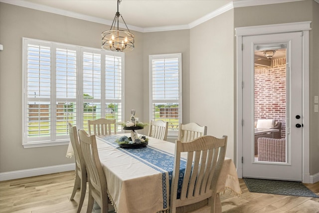 2141 Vanderbilt Dr, Weatherford, TX 76088 - dining area featuring a chandelier, baseboards, light wood-style floors, and crown molding