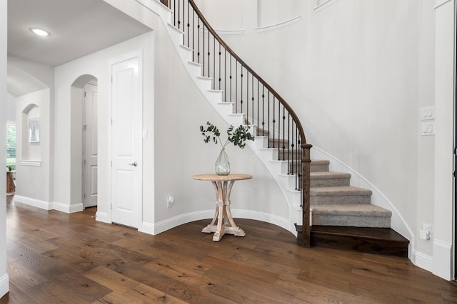 1112 Armadillo Trl, Argyle, TX 76226 - staircase featuring arched walkways, wood finished floors, and recessed lighting