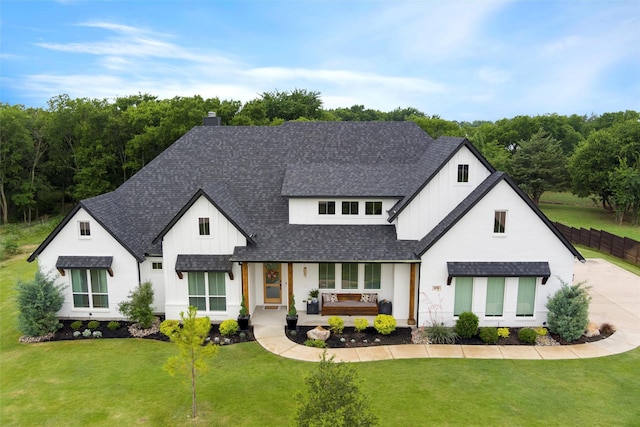450 Cobb Ln, Waxahachie, TX 75167 - view of front facade with a porch, a shingled roof, board and batten siding, and a front yard