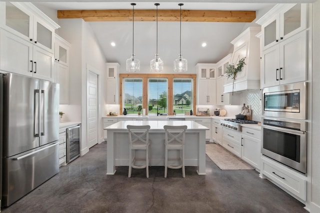 450 Cobb Ln, Waxahachie, TX 75167 - kitchen featuring appliances with stainless steel finishes, wine cooler, concrete floors, decorative backsplash, and light countertops
