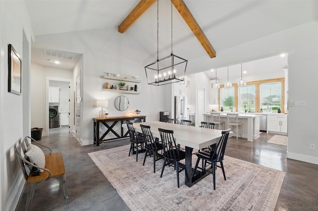 450 Cobb Ln, Waxahachie, TX 75167 - dining space featuring concrete flooring, washer / clothes dryer, beamed ceiling, baseboards, and a chandelier